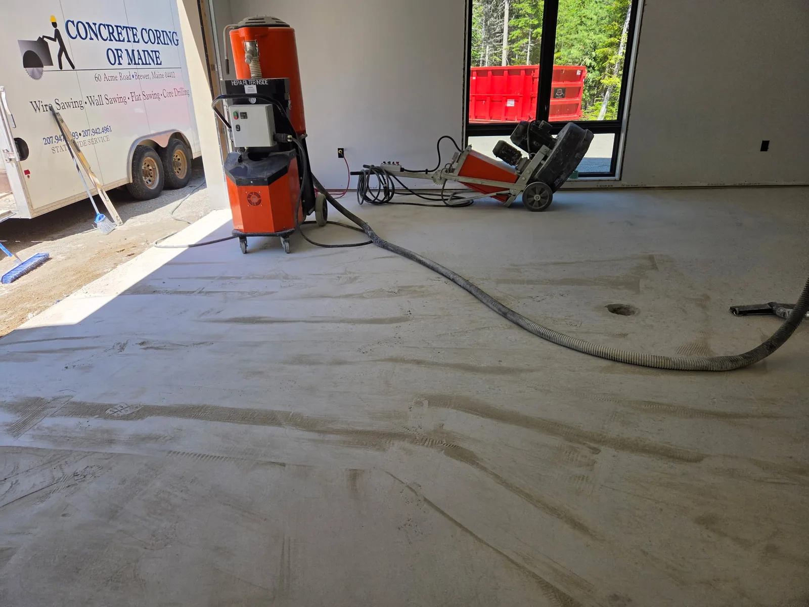 Orbital floor grinder and dust collection unit on a commercial concrete slab