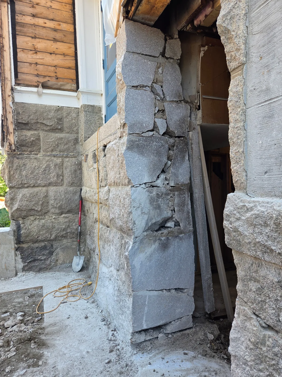 New opening cut through a granite block wall